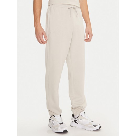 Champion Spodnie dresowe 220424 Écru Regular Fit ze sklepu MODIVO w kategorii Spodnie męskie - zdjęcie 182655018