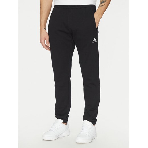 adidas Spodnie dresowe Trefoil Essentials JD2422 Czarny Slim Fit ze sklepu MODIVO w kategorii Spodnie męskie - zdjęcie 182663047
