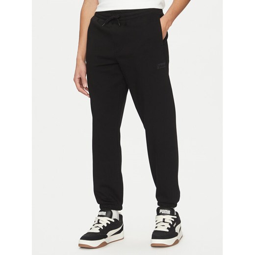 Vans Spodnie dresowe Core Basic VN000HQ2 Czarny Loose Fit ze sklepu MODIVO w kategorii Spodnie męskie - zdjęcie 182669296