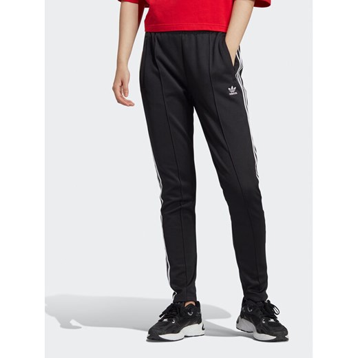 adidas Spodnie dresowe adicolor IB5916 Czarny Slim Fit ze sklepu MODIVO w kategorii Spodnie damskie - zdjęcie 182670657
