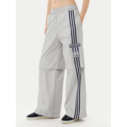 adidas Spodnie dresowe Adibreak JJ3122 Szary Regular Fit ze sklepu MODIVO w kategorii Spodnie damskie - zdjęcie 182675768