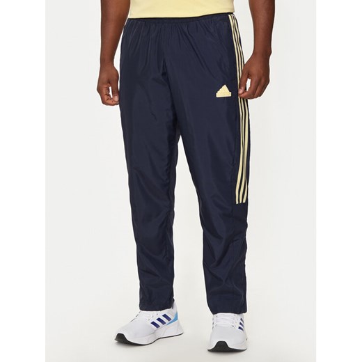 adidas Spodnie dresowe House of Tiro IW3582 Granatowy Regular Fit ze sklepu MODIVO w kategorii Spodnie męskie - zdjęcie 182677435