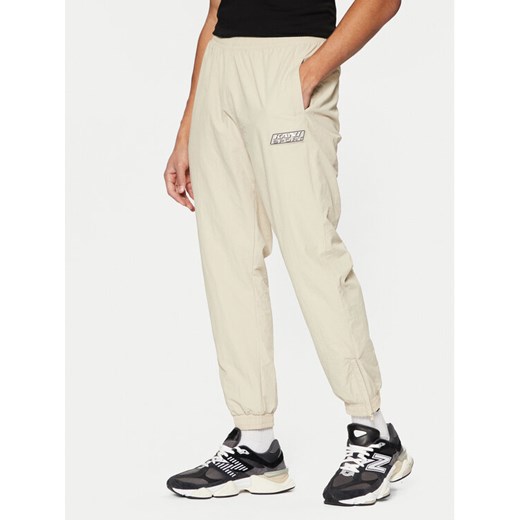 Karl Kani Spodnie dresowe Sport Patch Essential 60030075 Beżowy Relaxed Fit ze sklepu MODIVO w kategorii Spodnie męskie - zdjęcie 182687525