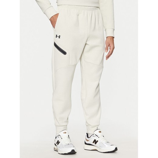 Under Armour Spodnie dresowe UA Unstoppable 1386544 Écru Regular Fit ze sklepu MODIVO w kategorii Spodnie męskie - zdjęcie 182688335