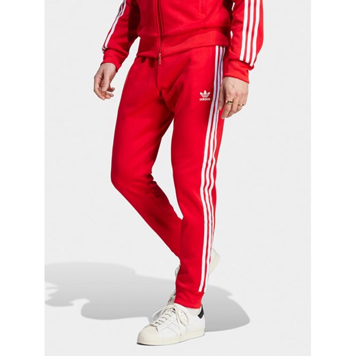 adidas Spodnie dresowe adicolor Classics SST IM4543 Czerwony Slim Fit ze sklepu MODIVO w kategorii Spodnie męskie - zdjęcie 182690429