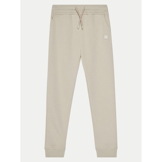 Calvin Klein Jeans Spodnie dresowe IU0IU00621 Beżowy Regular Fit ze sklepu MODIVO w kategorii Spodnie dziewczęce - zdjęcie 182707837