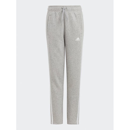 adidas Spodnie dresowe Essentials 3-Stripes IC6127 Szary Slim Fit ze sklepu MODIVO w kategorii Spodnie chłopięce - zdjęcie 182709289