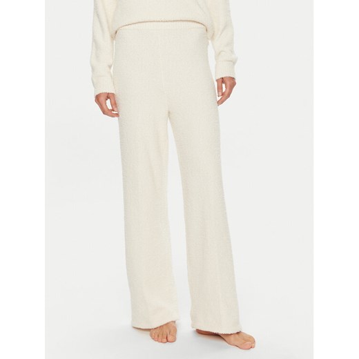 Calvin Klein Spodnie piżamowe 000QS7338E Écru Relaxed Fit ze sklepu MODIVO w kategorii Piżamy damskie - zdjęcie 182717045