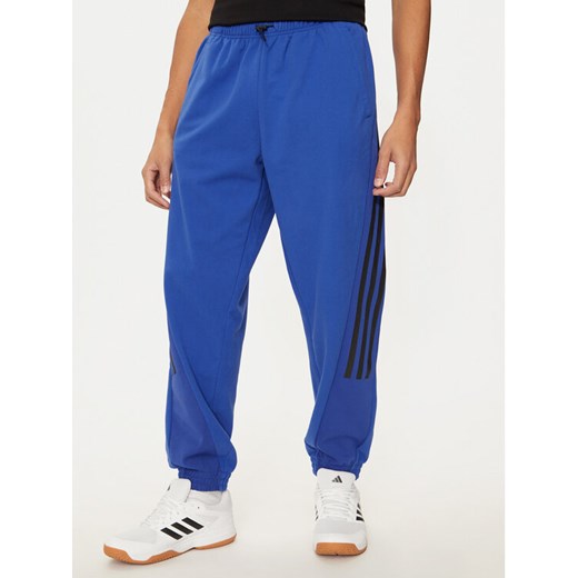 adidas Spodnie dresowe Future Icons 3-Stripes Polar IV5131 Niebieski Regular Fit ze sklepu MODIVO w kategorii Spodnie męskie - zdjęcie 182717779