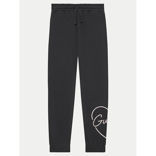 Guess Spodnie dresowe J4YQ16 KA6R3 Czarny Relaxed Fit ze sklepu MODIVO w kategorii Spodnie chłopięce - zdjęcie 182721007