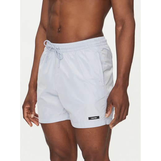 Calvin Klein Swimwear Szorty kąpielowe KM0KM01111 Niebieski Regular Fit ze sklepu MODIVO w kategorii Kąpielówki - zdjęcie 182722196