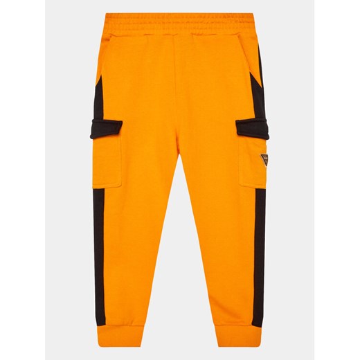 Guess Spodnie dresowe N3YQ12 KA6R3 Pomarańczowy Regular Fit ze sklepu MODIVO w kategorii Spodnie chłopięce - zdjęcie 182726515
