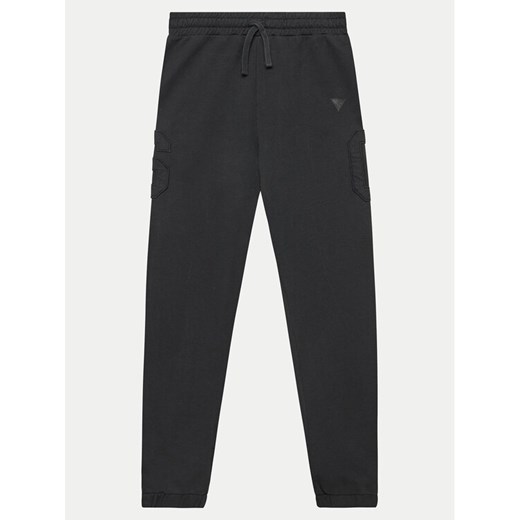 Guess Spodnie dresowe L4YQ13 KAD73 Czarny Relaxed Fit ze sklepu MODIVO w kategorii Spodnie chłopięce - zdjęcie 182730019