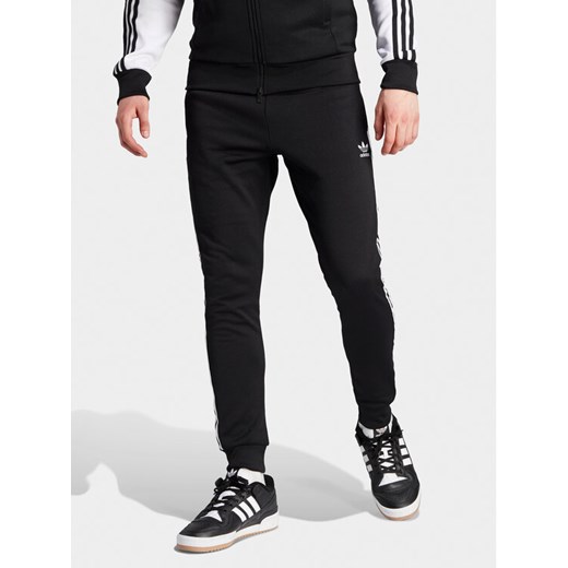 adidas Spodnie dresowe adicolor Classics SST IL2488 Czarny Slim Fit ze sklepu MODIVO w kategorii Spodnie męskie - zdjęcie 182731337