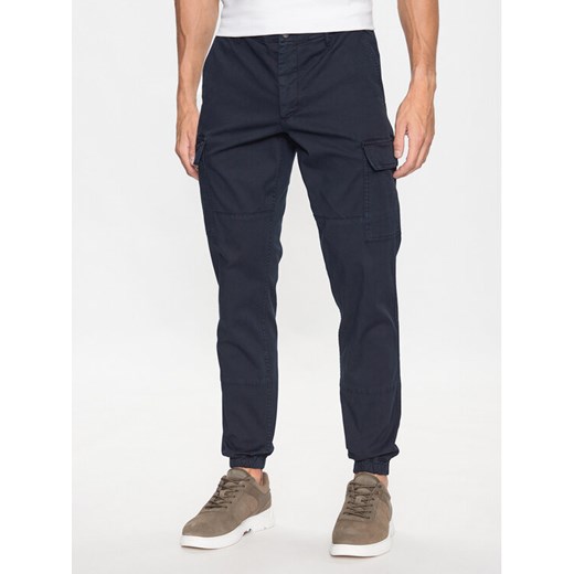 Tommy Hilfiger Joggery Chelsea MW0MW31149 Granatowy Relaxed Fit ze sklepu MODIVO w kategorii Spodnie męskie - zdjęcie 182734889