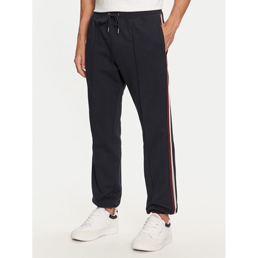 Tommy Hilfiger Spodnie dresowe MW0MW35548 Granatowy Regular Fit ze sklepu MODIVO w kategorii Spodnie męskie - zdjęcie 182736049