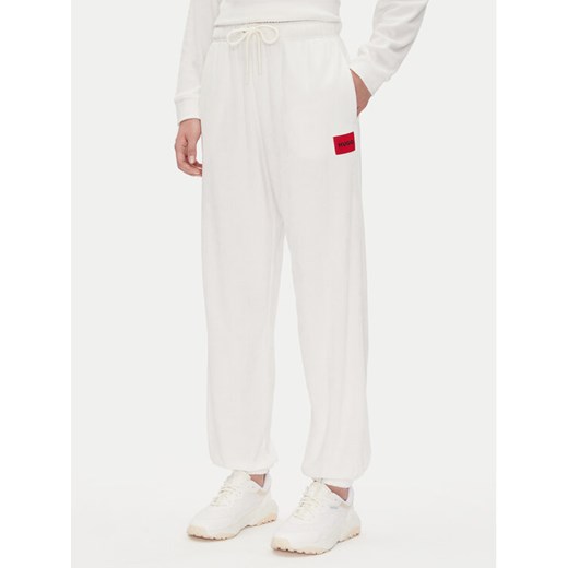 HUGO Spodnie dresowe Neve_Pants 50531692 Écru Relaxed Fit ze sklepu MODIVO w kategorii Spodnie damskie - zdjęcie 182737606