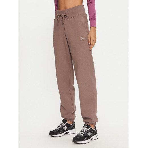 Karl Kani Spodnie dresowe Small Signature 61030014 Beżowy Relaxed Fit ze sklepu MODIVO w kategorii Spodnie damskie - zdjęcie 182739806