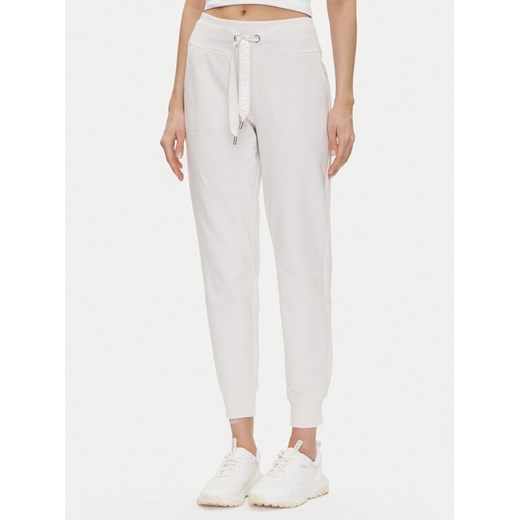 DKNY Sport Spodnie dresowe DP5P3496 Beżowy Regular Fit ze sklepu MODIVO w kategorii Spodnie damskie - zdjęcie 182753797