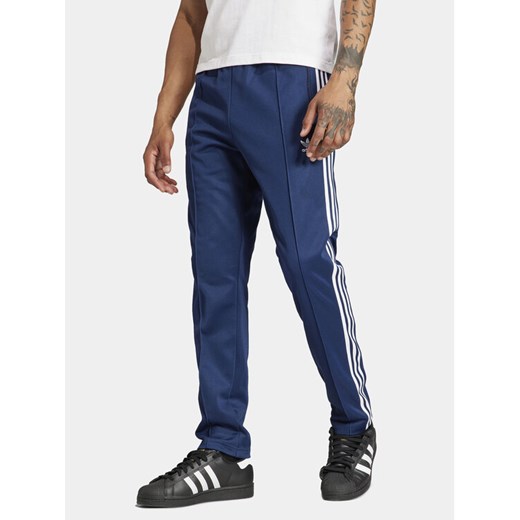adidas Spodnie dresowe adicolor Classics Beckenbauer IP0421 Niebieski Slim Fit ze sklepu MODIVO w kategorii Spodnie męskie - zdjęcie 182755088