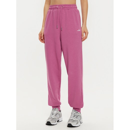 Fila Spodnie dresowe Buetzow FAW0701 Różowy Regular Fit ze sklepu MODIVO w kategorii Spodnie damskie - zdjęcie 182760139