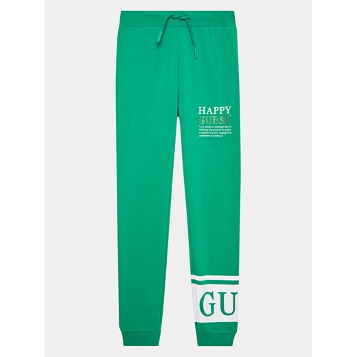 Guess Spodnie dresowe J3YQ11 KA6R4 Zielony Regular Fit ze sklepu MODIVO w kategorii Spodnie chłopięce - zdjęcie 182762227