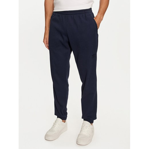 adidas Spodnie dresowe Trefoil Essentials IY2305 Granatowy Regular Fit ze sklepu MODIVO w kategorii Spodnie męskie - zdjęcie 183578336