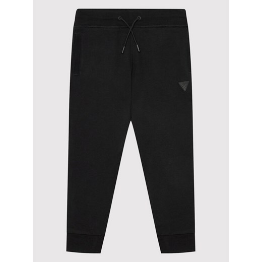 Guess Spodnie dresowe L2YQ46 KAIJ1 Czarny Regular Fit ze sklepu MODIVO w kategorii Spodnie chłopięce - zdjęcie 183631499