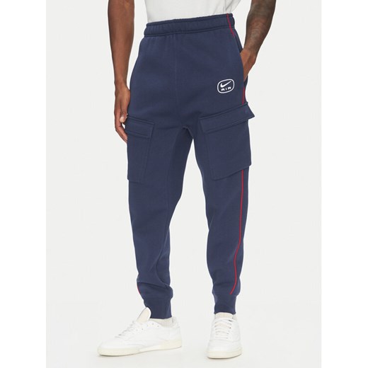 Nike Spodnie dresowe HM0180 Granatowy Regular Fit ze sklepu MODIVO w kategorii Spodnie męskie - zdjęcie 183652669