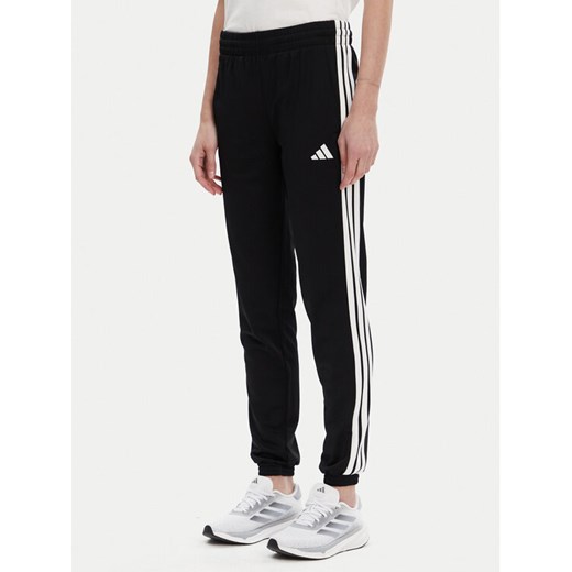 adidas Spodnie dresowe Tricot 3-Stripes JF3383 Czarny Regular Fit ze sklepu MODIVO w kategorii Spodnie damskie - zdjęcie 183737257