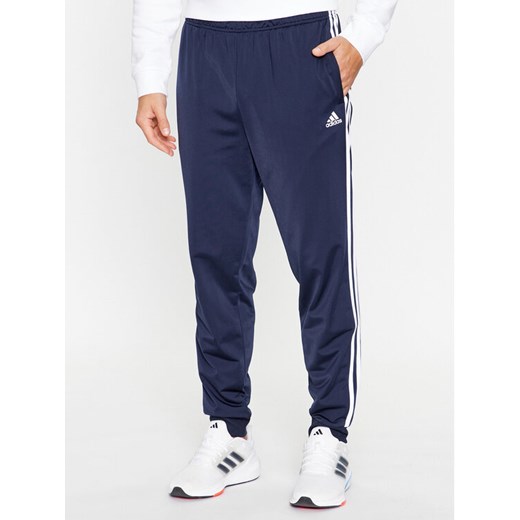 adidas Spodnie dresowe Essentials Warm-Up 3-Stripes H46106 Granatowy Regular Fit ze sklepu MODIVO w kategorii Spodnie męskie - zdjęcie 183946896
