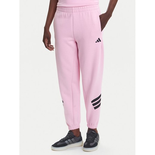 adidas Spodnie dresowe Future Icons 3-Stripes JE0158 Różowy Regular Fit ze sklepu MODIVO w kategorii Spodnie damskie - zdjęcie 184009935