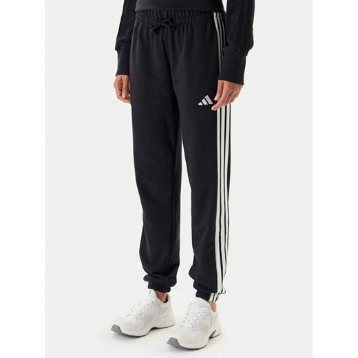 adidas Spodnie dresowe Essentials 3-Stripes JD5302 Czarny Regular Fit ze sklepu MODIVO w kategorii Spodnie damskie - zdjęcie 184019238