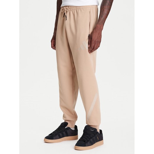 adidas Spodnie dresowe Z.N.E. JW4725 Beżowy Loose Fit ze sklepu MODIVO w kategorii Spodnie męskie - zdjęcie 184038436