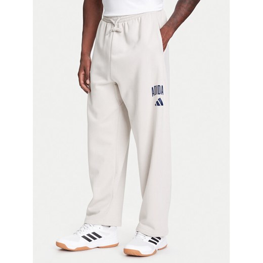 adidas Spodnie dresowe Collegiate JM9177 Beżowy Regular Fit ze sklepu MODIVO w kategorii Spodnie męskie - zdjęcie 184045645