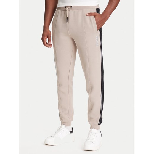 Guess Spodnie dresowe Z2YB09 KB3P2 Beżowy Regular Fit ze sklepu MODIVO w kategorii Spodnie męskie - zdjęcie 184164958