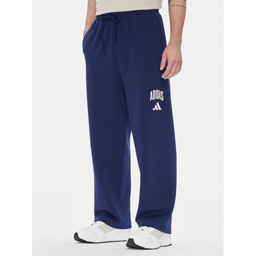 adidas Spodnie dresowe Collegiate JM9179 Niebieski Regular Fit ze sklepu MODIVO w kategorii Spodnie męskie - zdjęcie 184269446