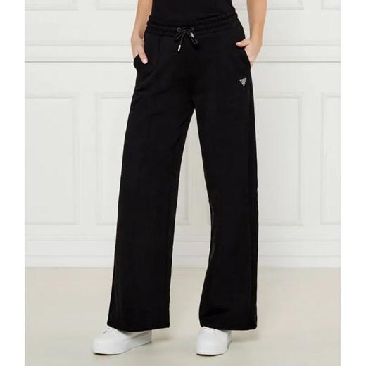 GUESS ACTIVE Spodnie dresowe PRIMULA | flare fit ze sklepu Gomez Fashion Store w kategorii Spodnie damskie - zdjęcie 184509635