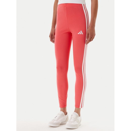 adidas Legginsy Essentials 3-Stripes KE4389 Koralowy Slim Fit ze sklepu MODIVO w kategorii Spodnie damskie - zdjęcie 184562168