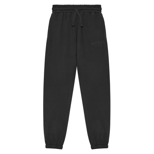Guess Spodnie dresowe L5YQ19 KAV34 Czarny Regular Fit ze sklepu MODIVO w kategorii Spodnie chłopięce - zdjęcie 184575317