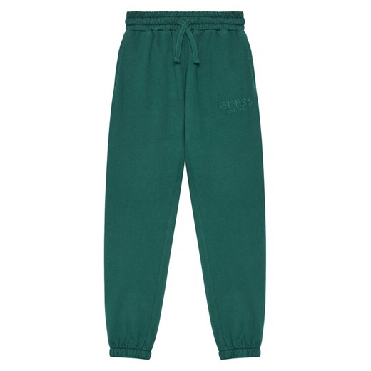 Guess Spodnie dresowe L5YQ19 KAV34 Zielony Regular Fit ze sklepu MODIVO w kategorii Spodnie chłopięce - zdjęcie 184575359