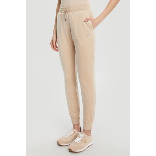 GUESS Beżowe damskie spodnie dresowe Couture, Rozmiar XS ze sklepu outfit.pl w kategorii Spodnie damskie - zdjęcie 184734249