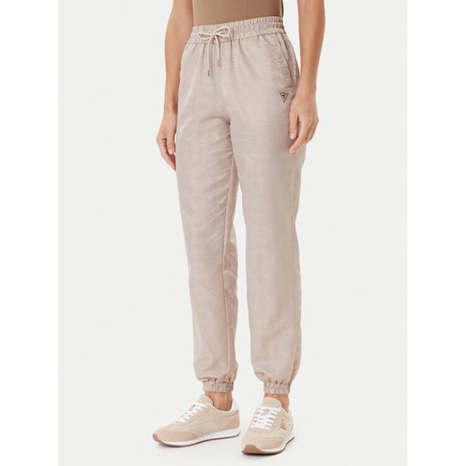 Guess Spodnie dresowe V5YB14 WHFU0 Beżowy Regular Fit ze sklepu MODIVO w kategorii Spodnie damskie - zdjęcie 184848896
