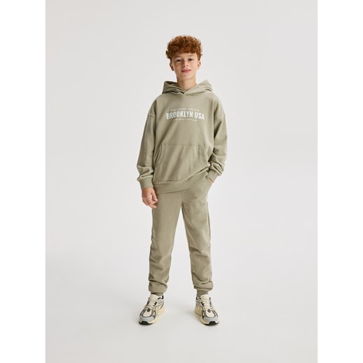 Reserved - Bawełniane spodnie jogger - jasnozielony ze sklepu Reserved w kategorii Spodnie chłopięce - zdjęcie 184850746