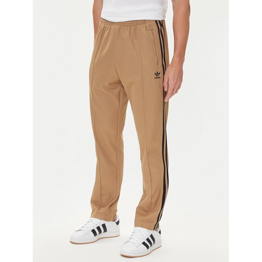 adidas Spodnie dresowe adicolor Classics Beckenbauer JY1276 Beżowy Slim Fit ze sklepu MODIVO w kategorii Spodnie męskie - zdjęcie 185040766