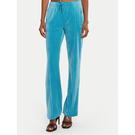 Juicy Couture Spodnie dresowe Tina JCAPW045 Niebieski Regular Fit ze sklepu MODIVO w kategorii Spodnie damskie - zdjęcie 185371756