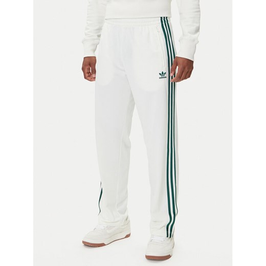 adidas Spodnie dresowe adicolor Classics Firebird KA0480 Biały Regular Fit ze sklepu MODIVO w kategorii Spodnie męskie - zdjęcie 185391598