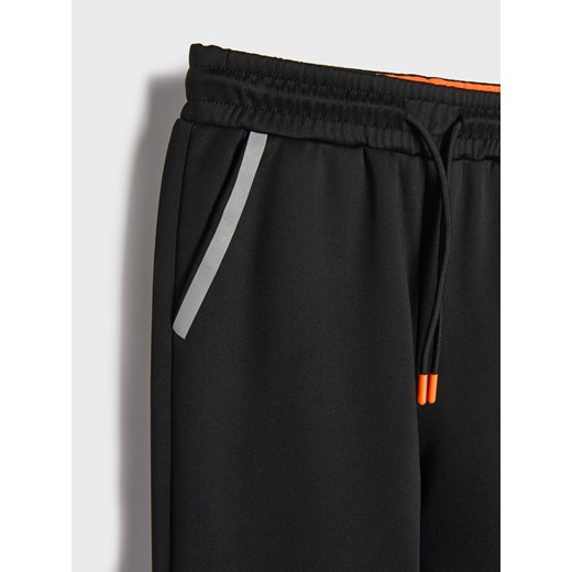 Sinsay - Spodnie sportowe z odblaskowymi elementami - czarny Sinsay 152 (11-12 l) Sinsay