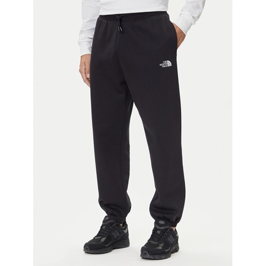 The North Face Spodnie dresowe Essential NF0A8C1F Czarny Relaxed Fit ze sklepu MODIVO w kategorii Spodnie męskie - zdjęcie 185792945