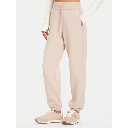 Guess Spodnie dresowe V5BB10 KB681 Beżowy Regular Fit ze sklepu MODIVO w kategorii Spodnie damskie - zdjęcie 186028945